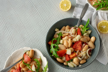 Ready to eat beans salad, healthy protein rich meal with fresh arugula leaves