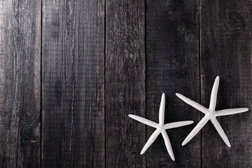 Fototapeta na wymiar Starfishes on wooden rustic background