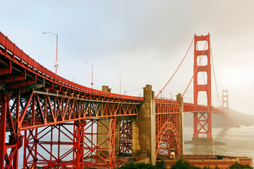 Fototapeta na wymiar Golden gate bridge in San Francisco at sunset with cloudy day. Having some copy space for design.