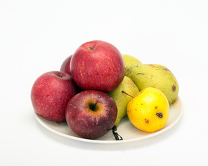 Fresh pears and apples on a light background