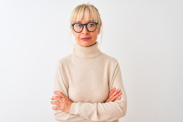 Middle age woman wearing turtleneck sweater and glasses over isolated white background Relaxed with serious expression on face. Simple and natural looking at the camera.