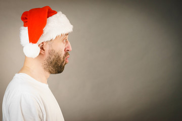 Surpriced man in santa claus hat