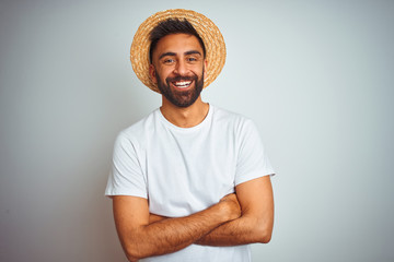 Young indian man on holiday wearing summer hat standing over isolated white background happy face...