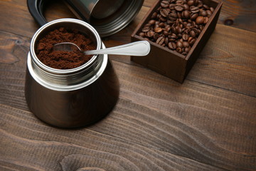 ground and grain coffee on a wooden background with copy space