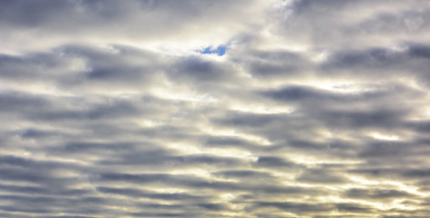 Beautiful puffy pastel colored clouds against blue skies.