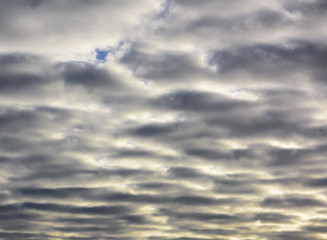 Beautiful puffy pastel colored clouds against blue skies.