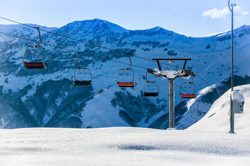 Empty chair ski Lift on Bright winter day.