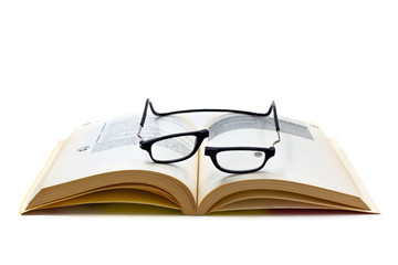Black neckband magnetic reading glasses on a book