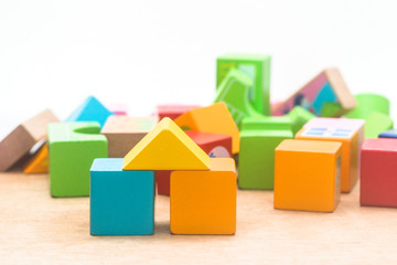 Naklejka premium Wooden blocks built on wooden boards and faded brick backgrounds