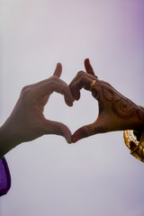 A Man and Woman Posing hands Like Heart Shape.