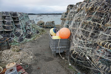 fishing nets and traps stacked on the edge of the harbor in Brittany, France