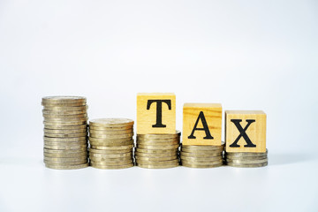 Business concept of tax on investment on white background, Stack coins and text box.