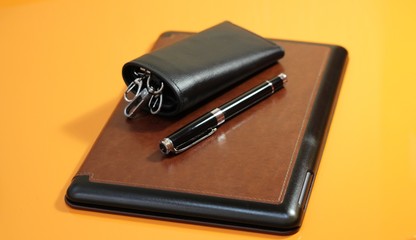 the housekeeper with a pen on an orange table