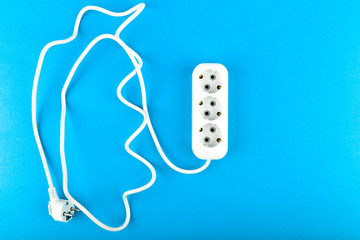 White socket with wire. View from above. on a blue background. White socket and extension cord....