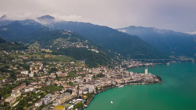 flight over montreux city lake bay sunny day storm sky aerial panorama 4k timelapse switzerland