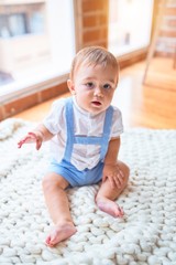 Beautiful toddler sitting on the blanket at kindergarten