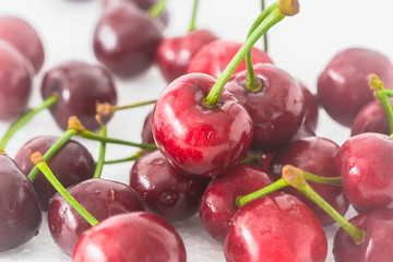 A few fresh cherries on a white background