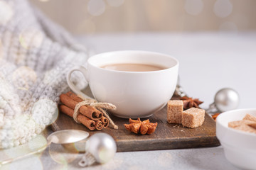 Obraz na płótnie Canvas White cup with coffee and marshmallow, sweater, cinnamon. Cozy christmas composition. Hygge concept Soft focus