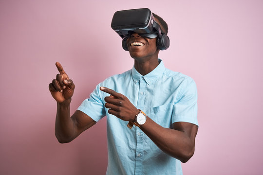 Young african american man playing virtual reality game using goggles