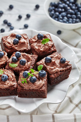 close-up of brownies with berries on a cake stand