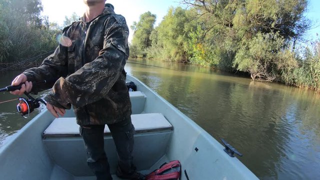 Fishing for Asp. Complete fishing process from casting to catching. Amateur angler catches the asp fish (Leuciscus aspius) from the boat. Part 1