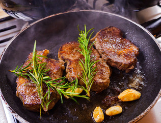 Grilled premium rib eye beef steak in the pan, cooking steak in the kitchen on a dark background, top view