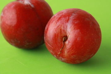 Delicious plums in colorful background