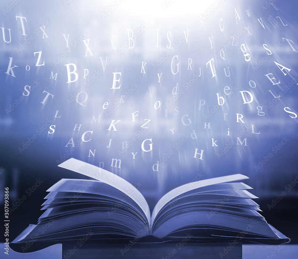 Poster imagine opening an old book blurred with magic power on the table and the english alphabet floating 