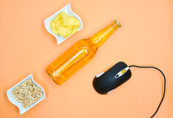 Composition with game computer mouse, beer and snack on  yellow background. Russia, Tatarstan, December 01, 2019