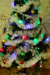 Christmas composition of multi-colored garland and Cristmas decor in green