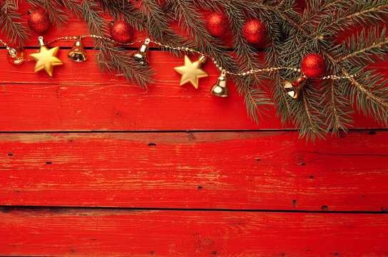 Red wooden background with Christmas decoration. Beautiful colored holiday element. Celebration. Merry Christmas.
