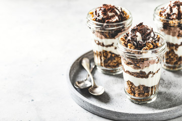 Yogurt parfait with granola, chocolate and ice cream. Sweet delicious breakfast