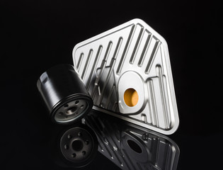 Various car or automotive parts on black background