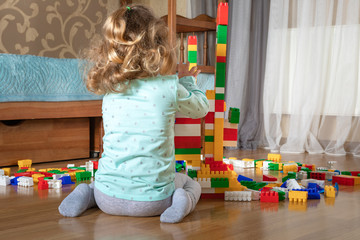 child little girl playing constructor. toys at home