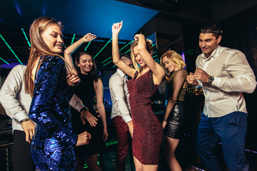 Young people dancing in night club