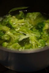 fresh green broccoli cooked boiled in a pan, boiling water