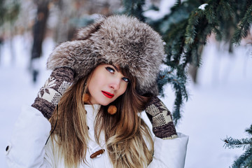 young woman in winter. snow, christmas trees in nature