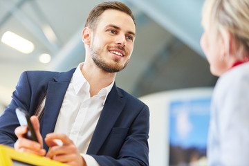 Young businessman as a traveler at the check-in