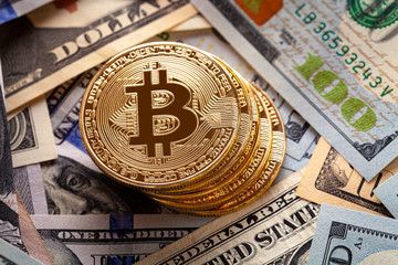 golden bitcoin coin on us dollars close up. Electronic crypto currency