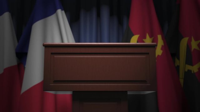Flags of France and Angola and speaker podium tribune. Political event or negotiations related conceptual 3D animation