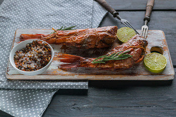 Close-up hot smoked fish on a wooden cutting board. Red sea bass fillet.