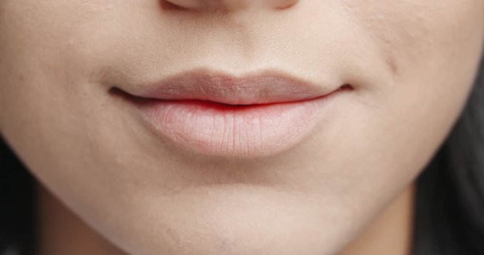 Close up shot of lips of a young girl making a beautiful positive sensual smile - emotions concept 4k footage