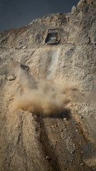 Dumper unloading stones from mine to dump