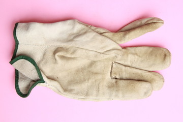used leather work gloves in color background