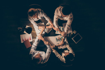 Top above high angle view of four hardworking people executive managers partners leaders shaking...