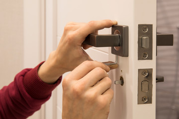 carpenter Installing the lock on the door Installation of the door lock.