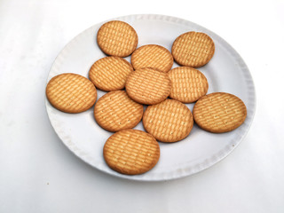 fresh healthy wheat biscuits put in a plate isolated on white background