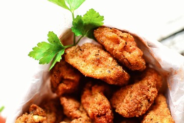 Chicken nuggets with a crispy crust. Delicious chicken meat on a wooden background. Fried meat, breast. 