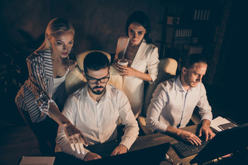 Photo of four business people partners working late night drink coffee workaholics watching...