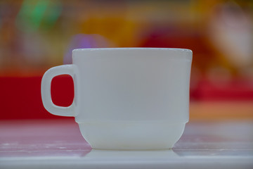 white cup on a table in a cafe
